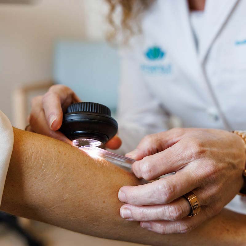 Dermatologist performing a skin cancer screening at the Lakewood Ranch SR 70 office