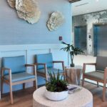 Modern waiting room with chairs and bright windows at the Arsenault Dermatology Venice location.